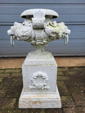 Antique cast iron vase with lion head and flowers