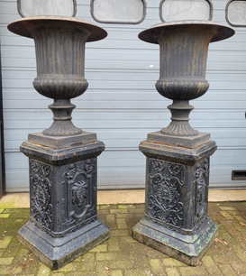 Large antique cast iron vases on column