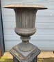Large antique cast iron vases on column