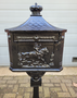 Antique cast iron English letterbox on a leg Black